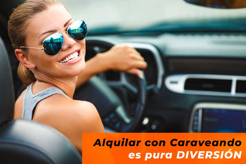 Girl at the wheel smiling, Caraveando's car rental service near me is the best way to have fun right from the start