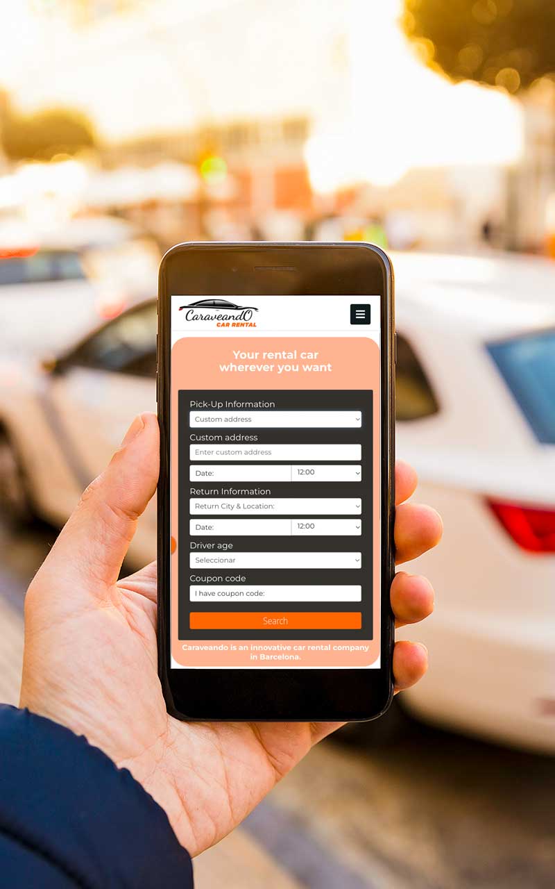 Man holding a smartphone showing Caraveando's car rental service near me, with personalised delivery.